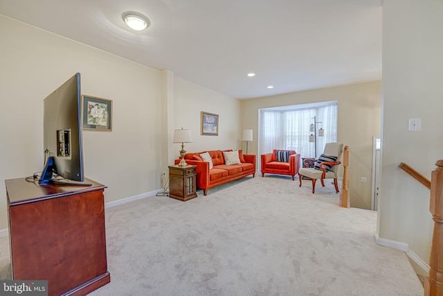 living area featuring recessed lighting, light carpet, and baseboards