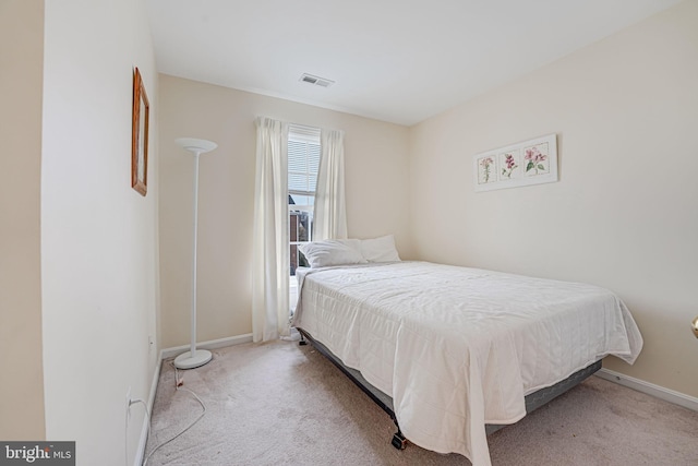 carpeted bedroom featuring baseboards and visible vents