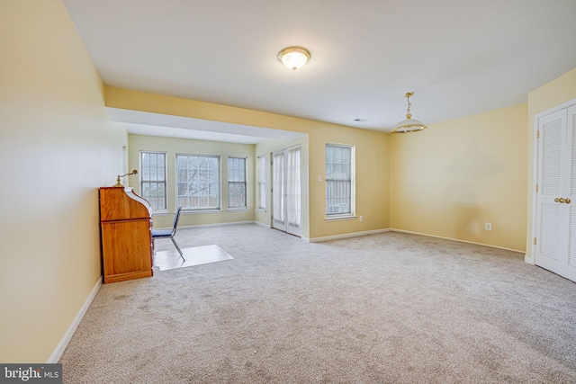 empty room with light carpet and baseboards