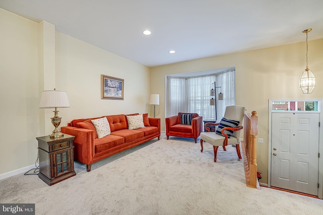 living room featuring baseboards, carpet floors, recessed lighting, and an inviting chandelier