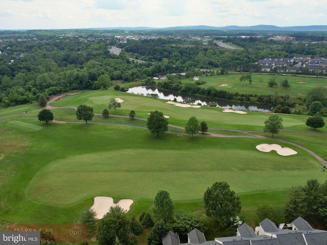 bird's eye view with view of golf course and a water view