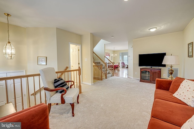 living area with light carpet, an inviting chandelier, stairs, and baseboards