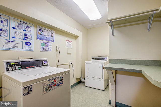 community laundry room with independent washer and dryer and light floors