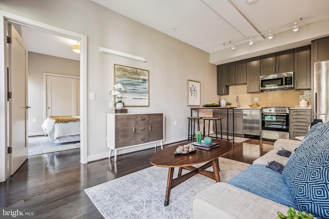 living room with dark wood-style floors and baseboards