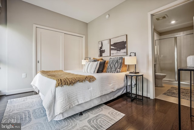 bedroom featuring baseboards, visible vents, dark wood finished floors, and a closet