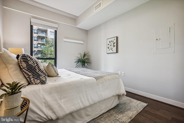 bedroom with baseboards, electric panel, visible vents, and dark wood-style flooring