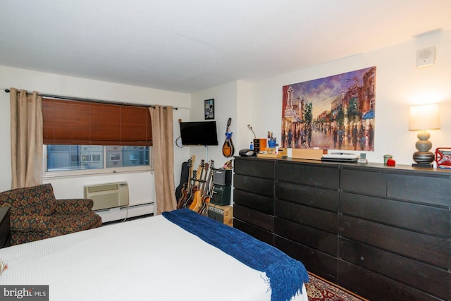 bedroom with a baseboard heating unit and a wall mounted AC