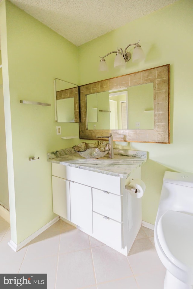 72 Arapaho Pl, Absecon, NJ 08205 - bathroom with a textured ceiling, vanity, tile patterned flooring, toilet, and baseboards