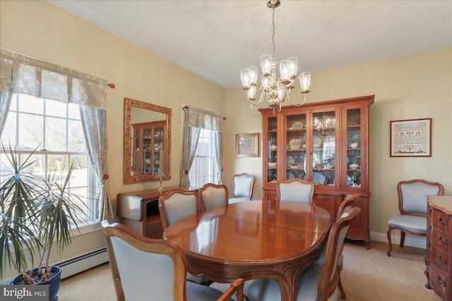 dining space featuring a healthy amount of sunlight, light carpet, and a baseboard heating unit