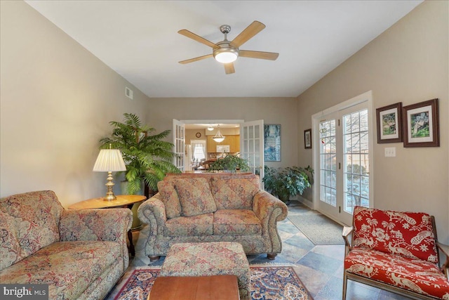 living room with ceiling fan and visible vents