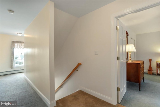 hall with baseboards, light colored carpet, and an upstairs landing