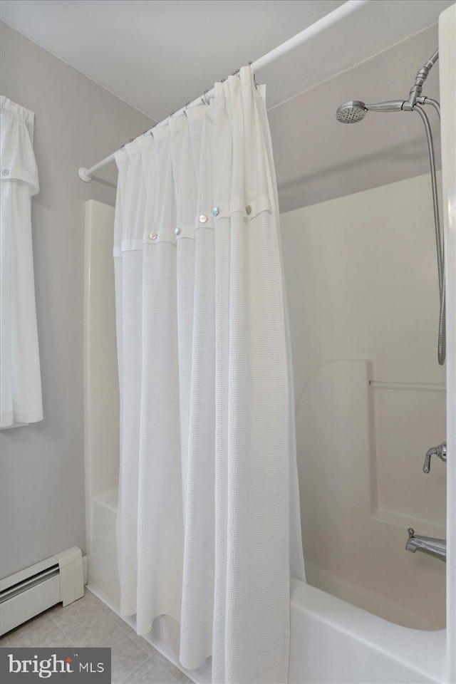 full bath with a baseboard heating unit and tile patterned flooring