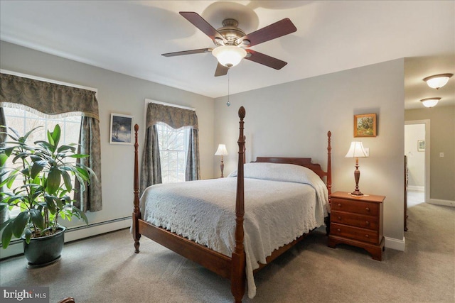carpeted bedroom featuring a ceiling fan, baseboards, and baseboard heating