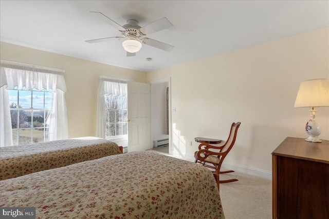 bedroom featuring a ceiling fan, a baseboard radiator, light colored carpet, and baseboards