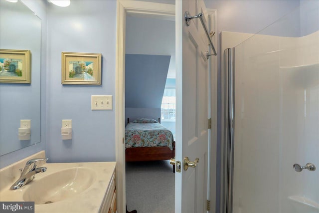 bathroom with ensuite bathroom, walk in shower, and vanity