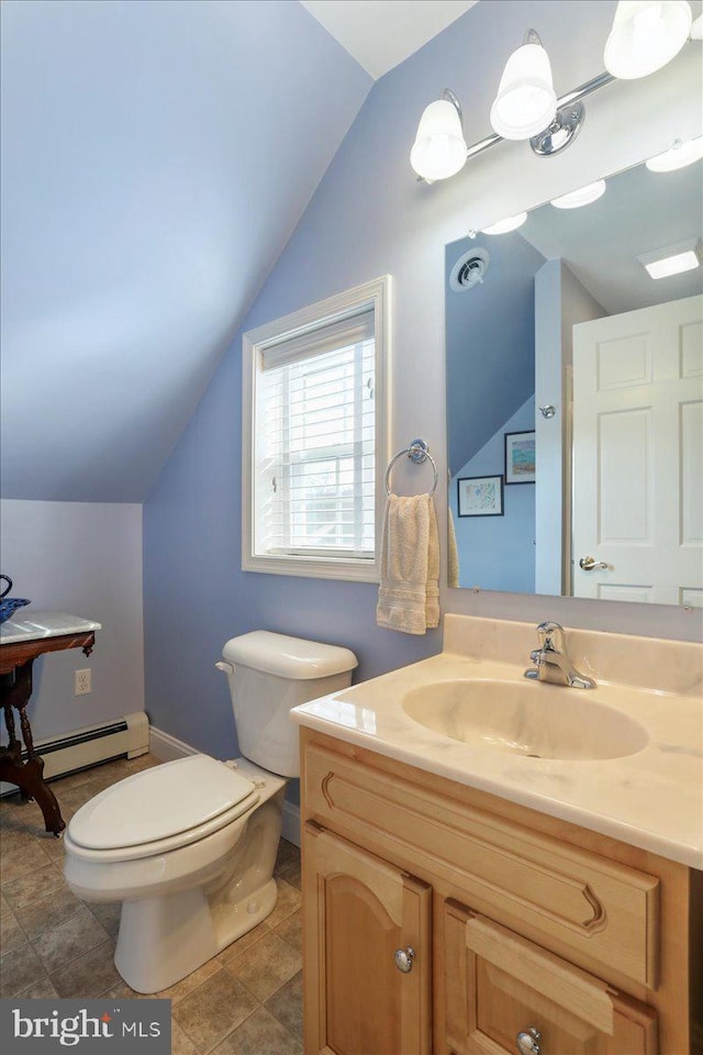 bathroom with visible vents, toilet, vaulted ceiling, vanity, and a baseboard heating unit