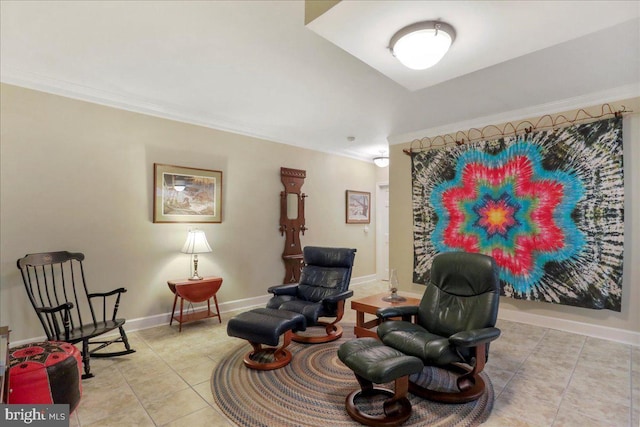 sitting room with light tile patterned floors, baseboards, and crown molding