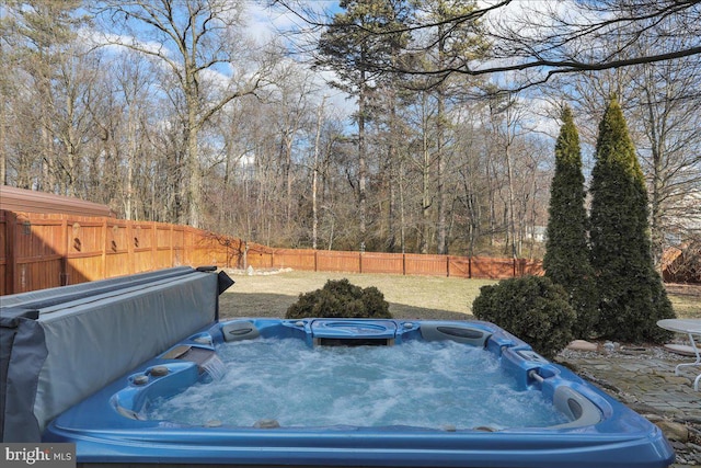 view of yard featuring a fenced backyard and a hot tub