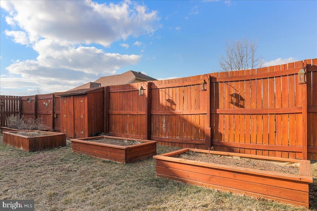 view of yard with fence and a vegetable garden