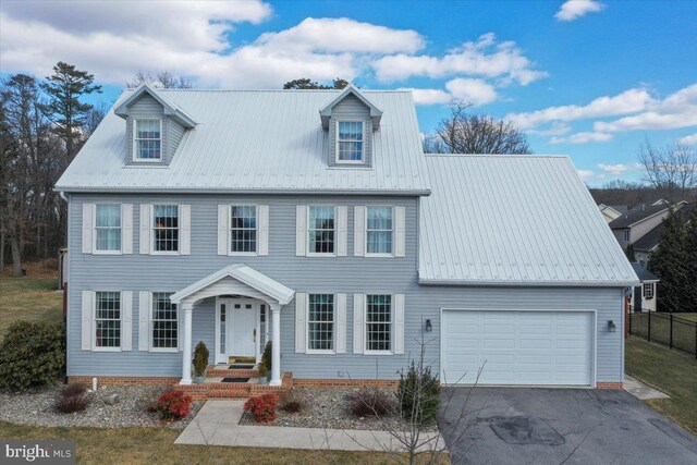 view of front of home featuring aphalt driveway and metal roof