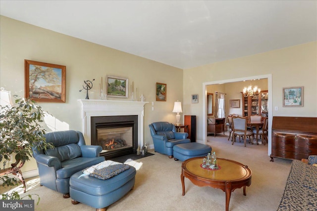 carpeted living room with a fireplace with flush hearth and an inviting chandelier