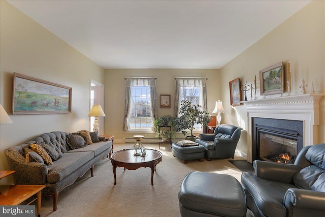 living area with a baseboard heating unit, carpet flooring, and a glass covered fireplace