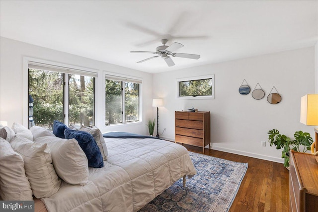 bedroom with wood finished floors, a ceiling fan, and baseboards