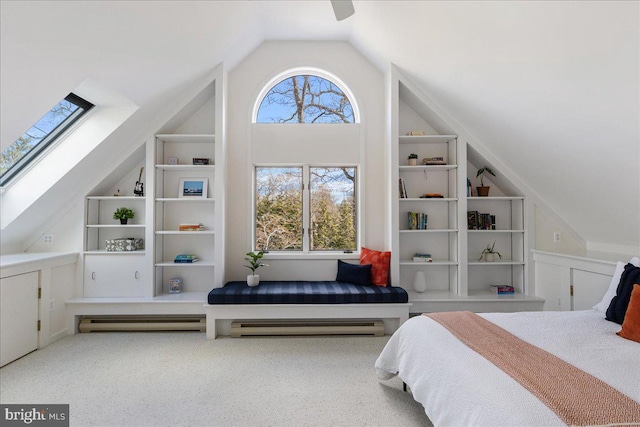 bedroom featuring vaulted ceiling with skylight, carpet flooring, and ceiling fan