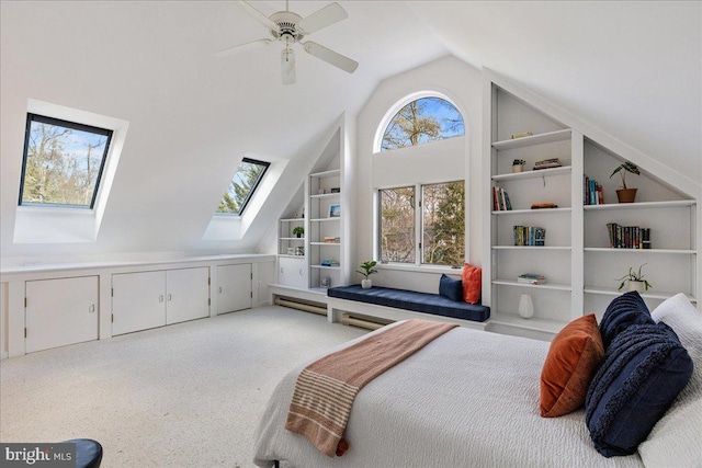 bedroom featuring high vaulted ceiling, a skylight, and a ceiling fan