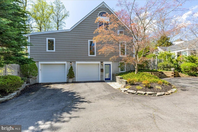 view of front facade featuring aphalt driveway and a garage