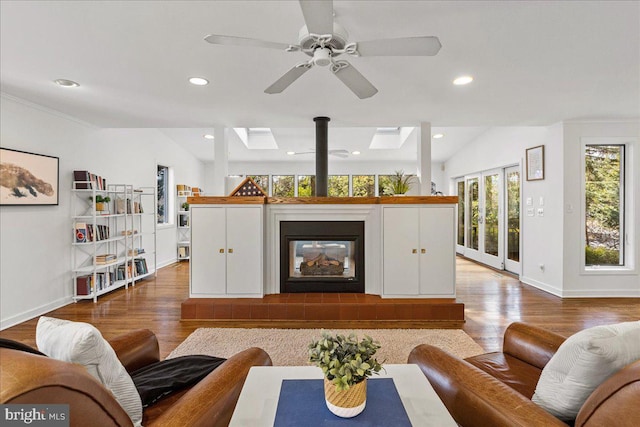 living room featuring baseboards, wood finished floors, and recessed lighting