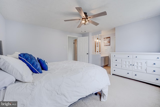 bedroom featuring ensuite bath and ceiling fan