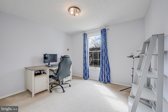 office space with a textured ceiling, baseboards, and light colored carpet