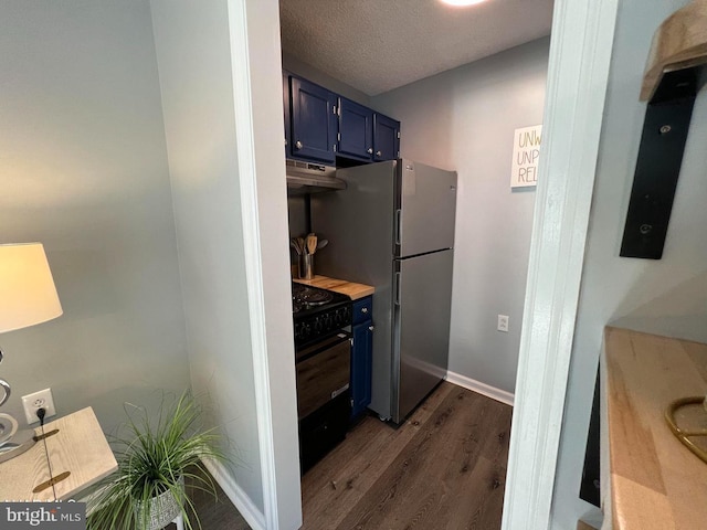 kitchen with a textured ceiling, under cabinet range hood, blue cabinets, black stove, and dark wood finished floors