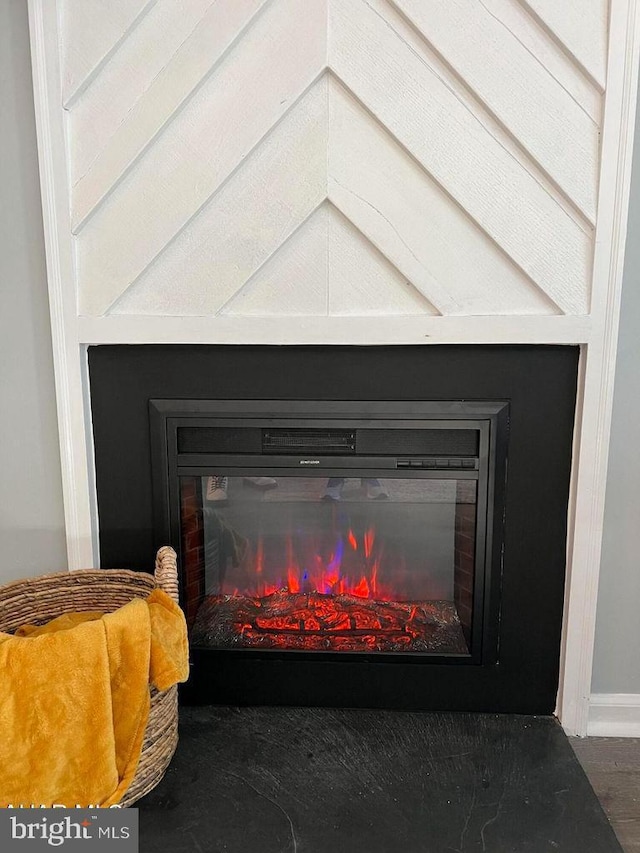 interior details with a glass covered fireplace