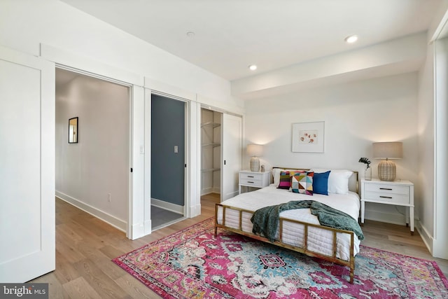 bedroom featuring recessed lighting, baseboards, and light wood finished floors