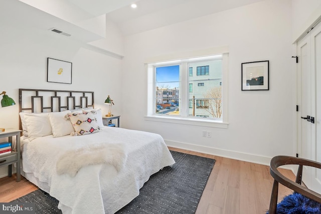 bedroom featuring recessed lighting, visible vents, baseboards, and wood finished floors