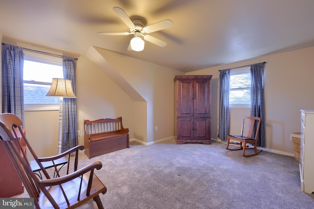 sitting room featuring light carpet, a ceiling fan, and baseboards