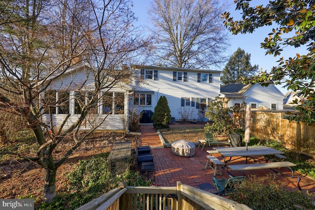 view of front facade with a patio and fence