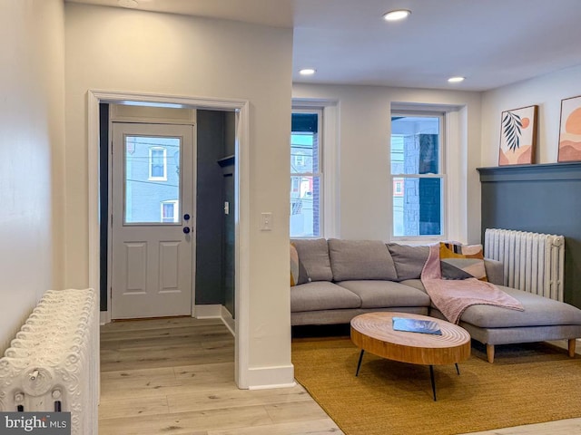 foyer entrance featuring light wood-style floors, recessed lighting, plenty of natural light, and radiator heating unit