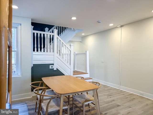 dining room with stairs, recessed lighting, and wood finished floors