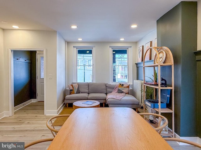 living room with light wood-type flooring, baseboards, and recessed lighting