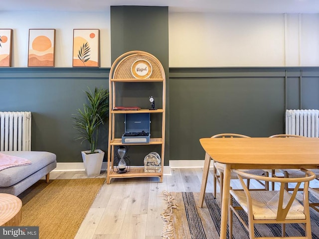 interior space with radiator, hardwood / wood-style flooring, and baseboards