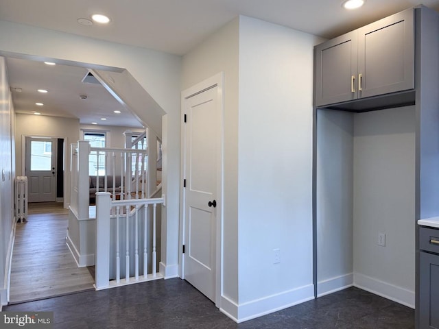 interior space featuring an upstairs landing, baseboards, and recessed lighting