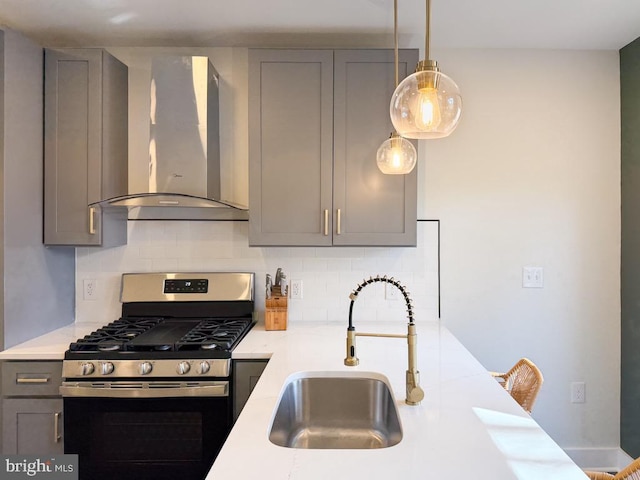 kitchen featuring wall chimney range hood and gray cabinetry