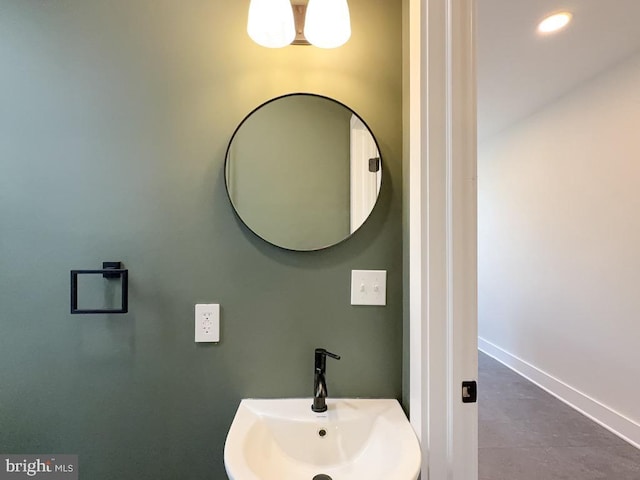 bathroom featuring recessed lighting, a sink, and baseboards