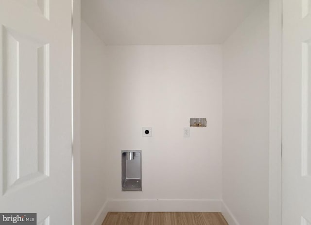 laundry area featuring baseboards, washer hookup, wood finished floors, and hookup for an electric dryer