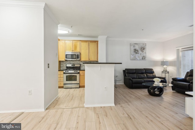 kitchen with dark countertops, appliances with stainless steel finishes, open floor plan, and a breakfast bar area