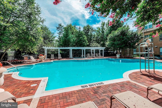 pool with fence and a pergola