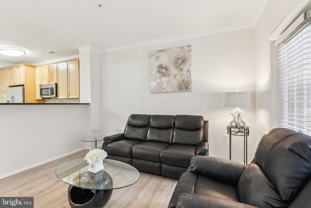 living area featuring ornamental molding, plenty of natural light, and light wood-style floors